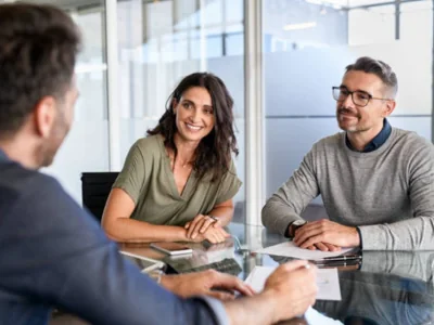 Illustrative legal consultation with clients seated across a desk